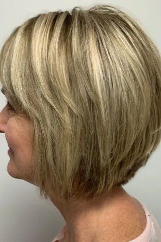 Rounded blonde bob haircut for women over 40, side view