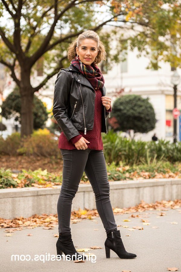 Thanksgiving outfit for women over 50: black leather jacket with plaid scarf