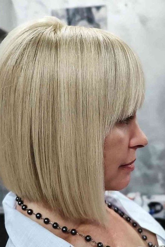 Platinum blonde bob with bangs for women over 40, side view