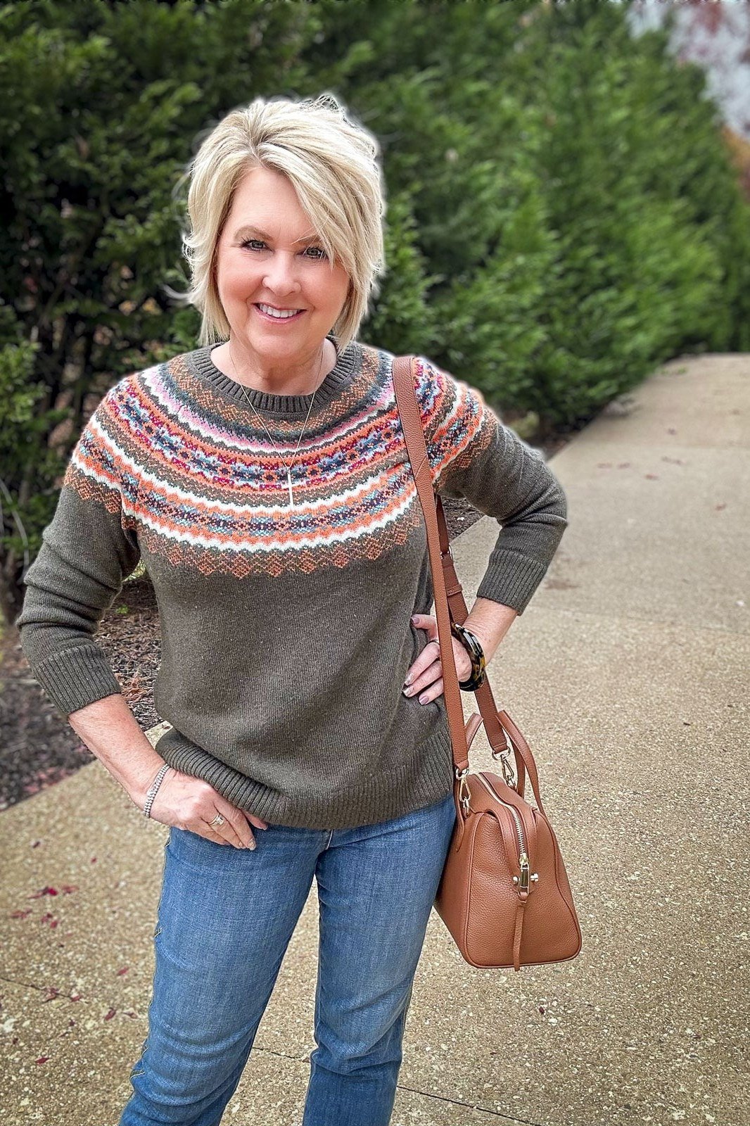 Thanksgiving outfit for women over 50: fair isle sweater with blue jeans