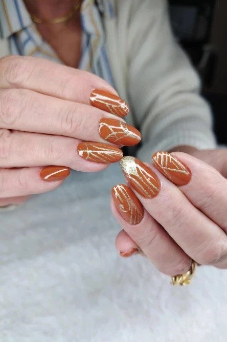 Burnt Orange Nails with White Swirls for women over 50
