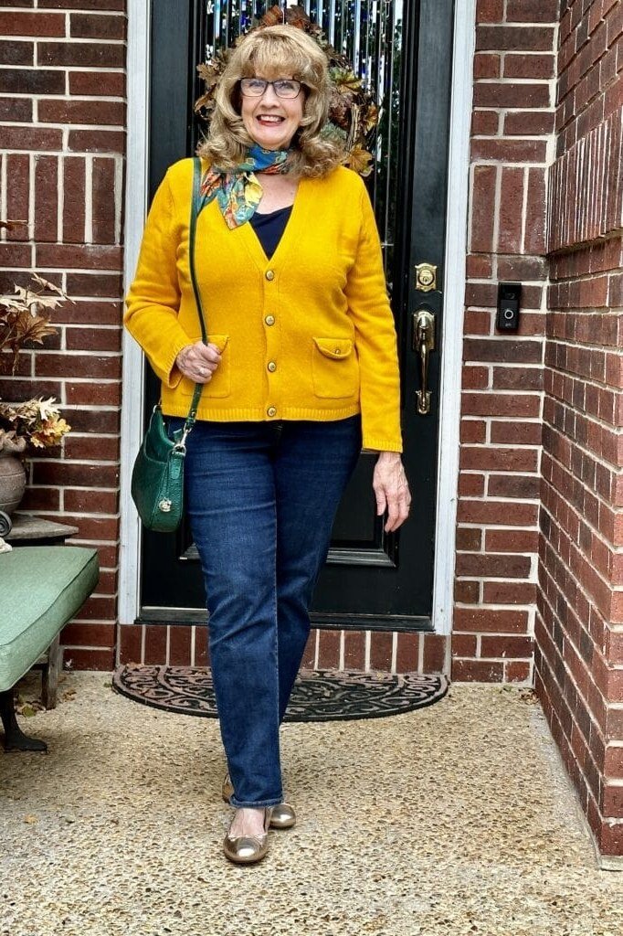 Thanksgiving outfit for women over 50: yellow quilted jacket with jeans