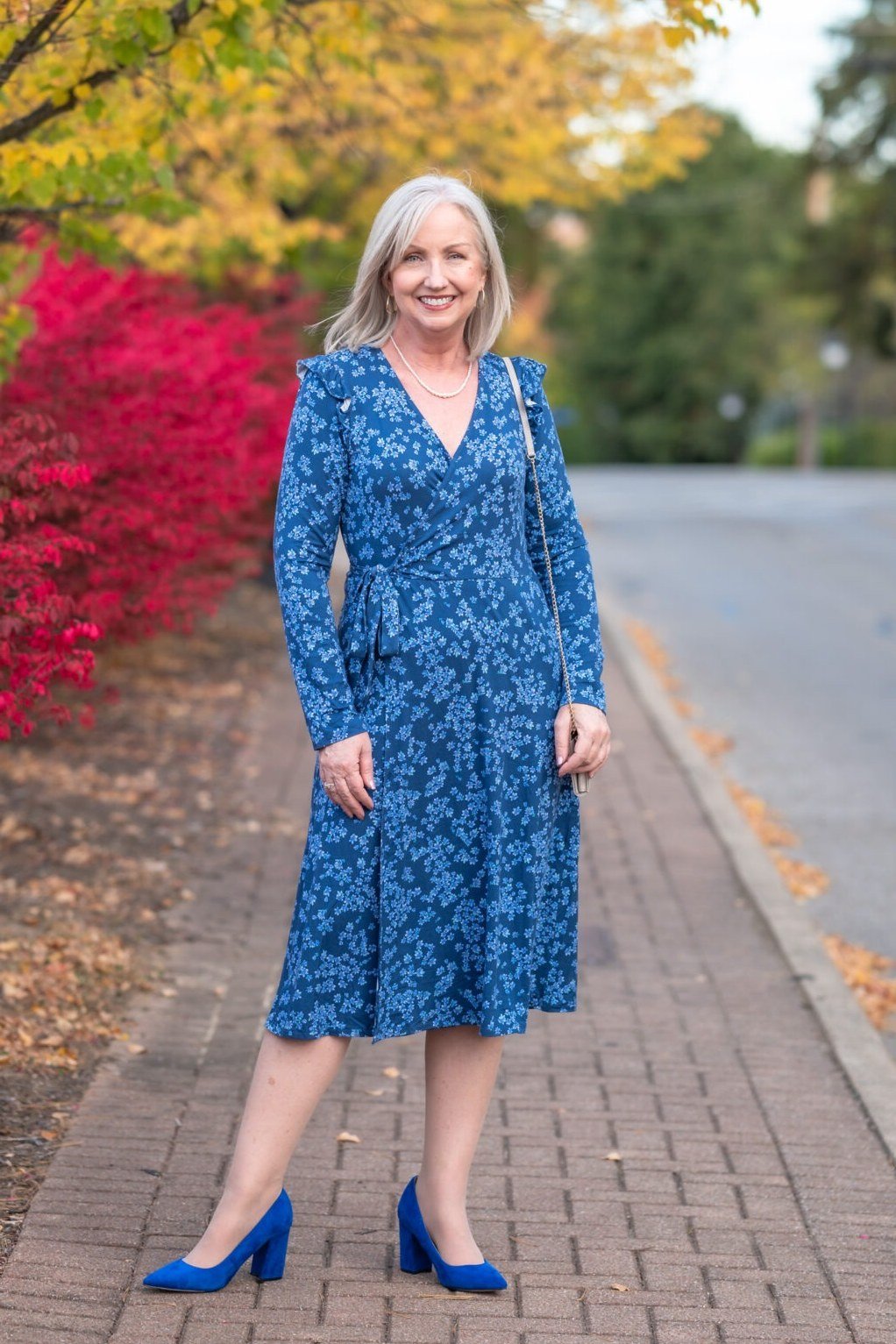 Thanksgiving outfit for women over 50: blue floral wrap dress with blue heels