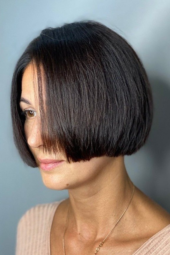 Sleek black bob haircut for women over 40, side view
