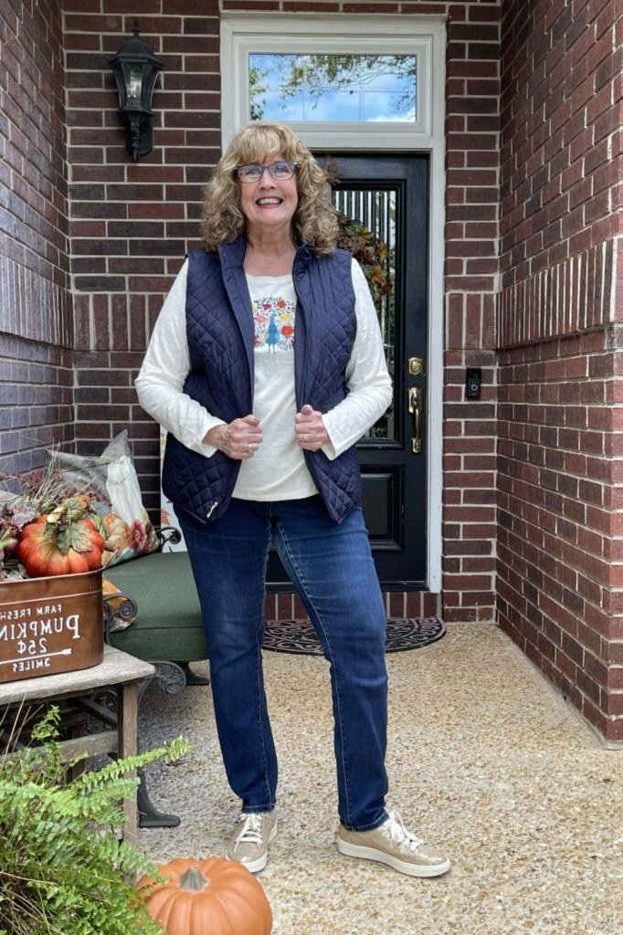 Thanksgiving outfit for women over 50: navy quilted vest with jeans
