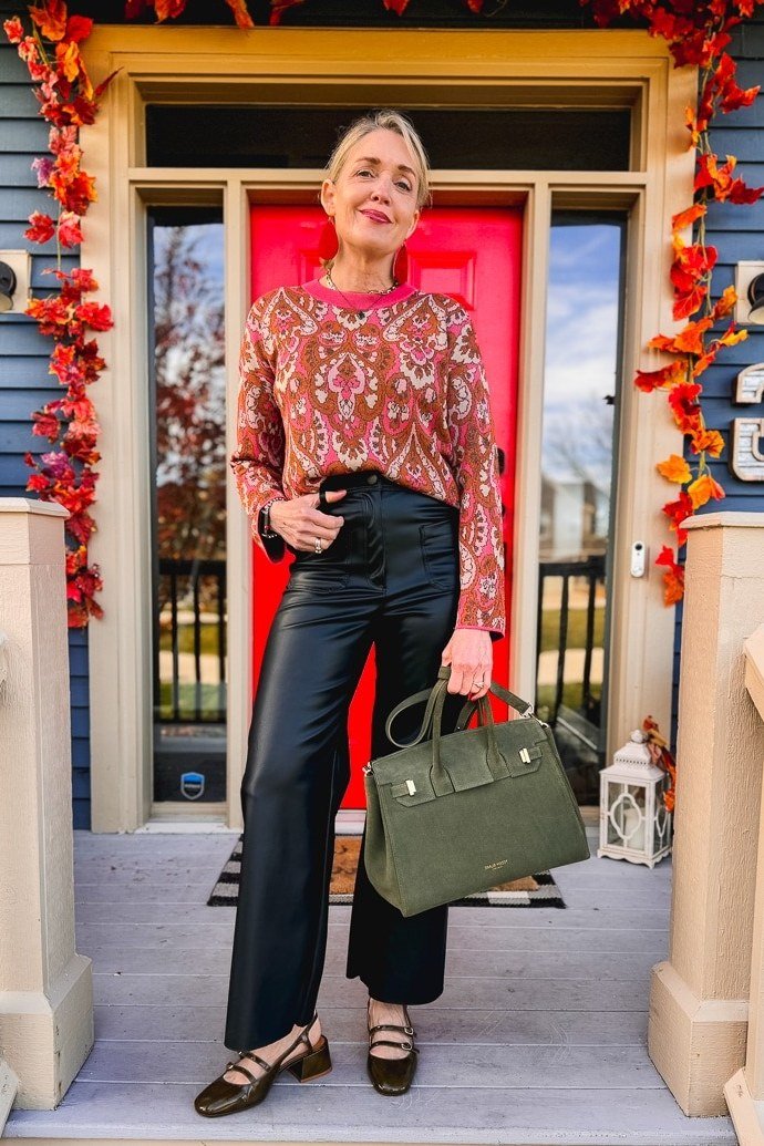 Thanksgiving outfit for women over 50: pink floral blouse with dark jeans