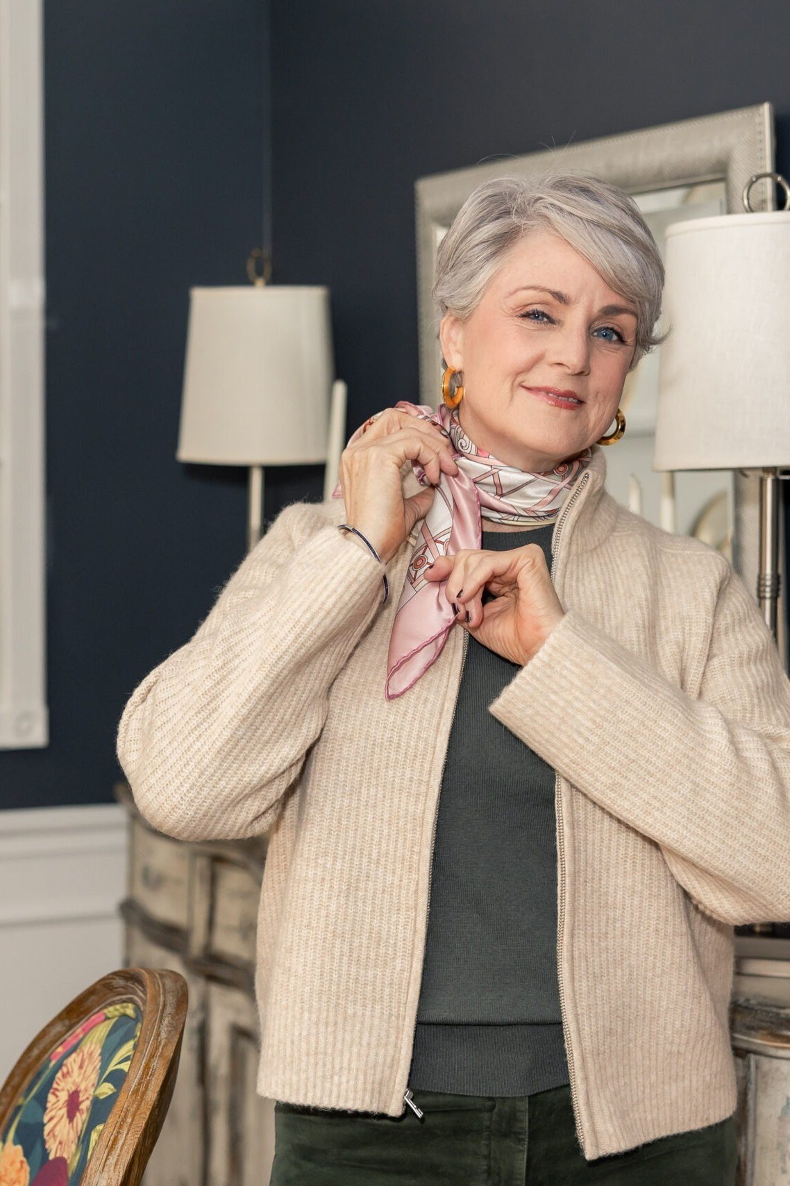 Thanksgiving outfit for women over 50: cream cardigan with scarf