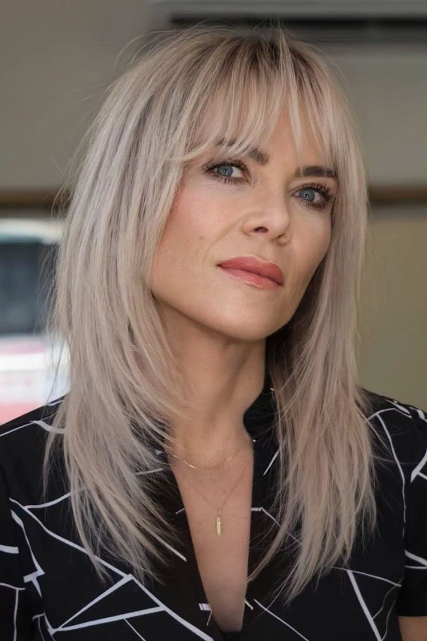 Silver straight medium hairstyle with bangs for women over 40