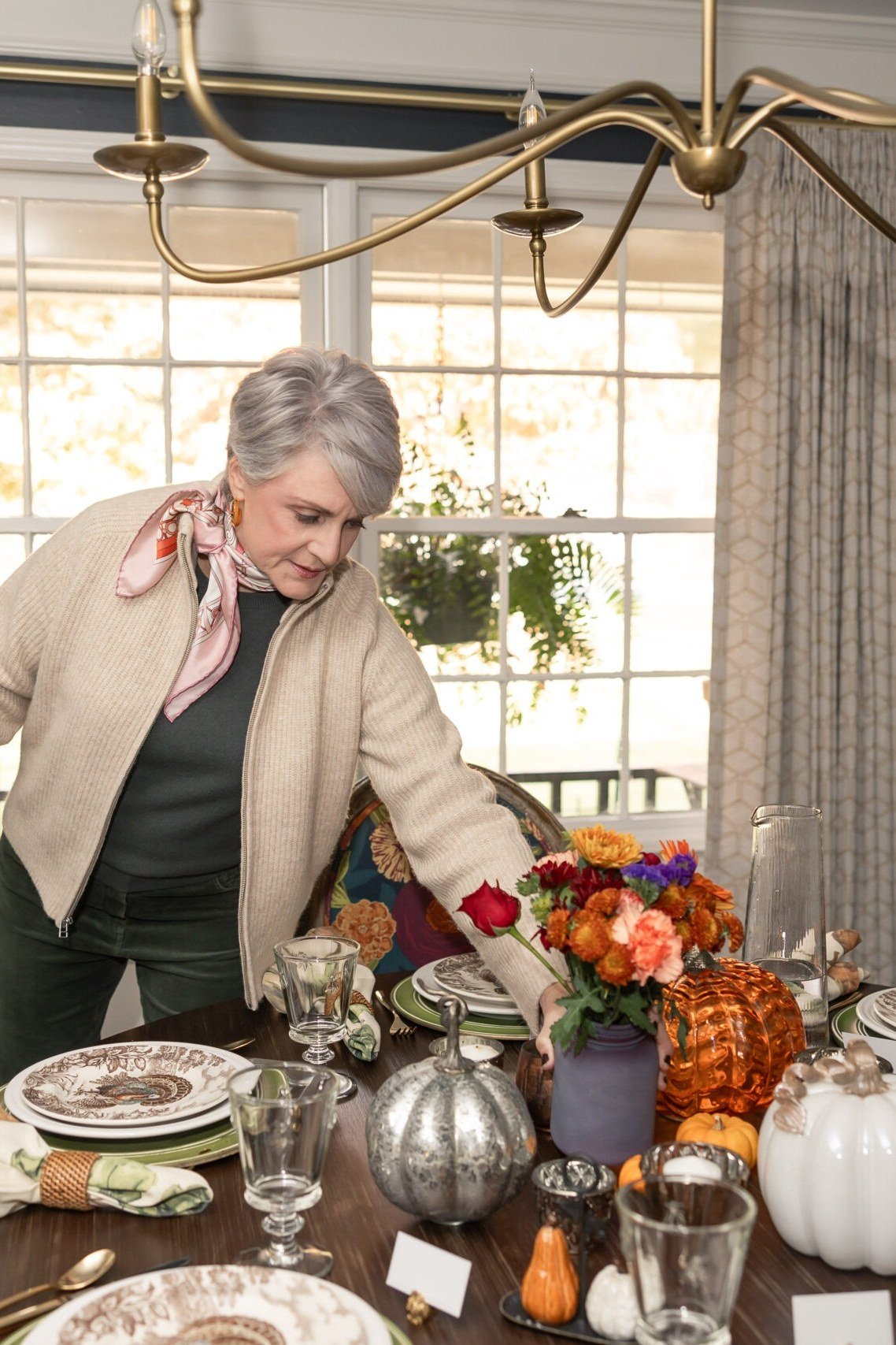 Thanksgiving outfit for women over 50: tan blazer setting the table