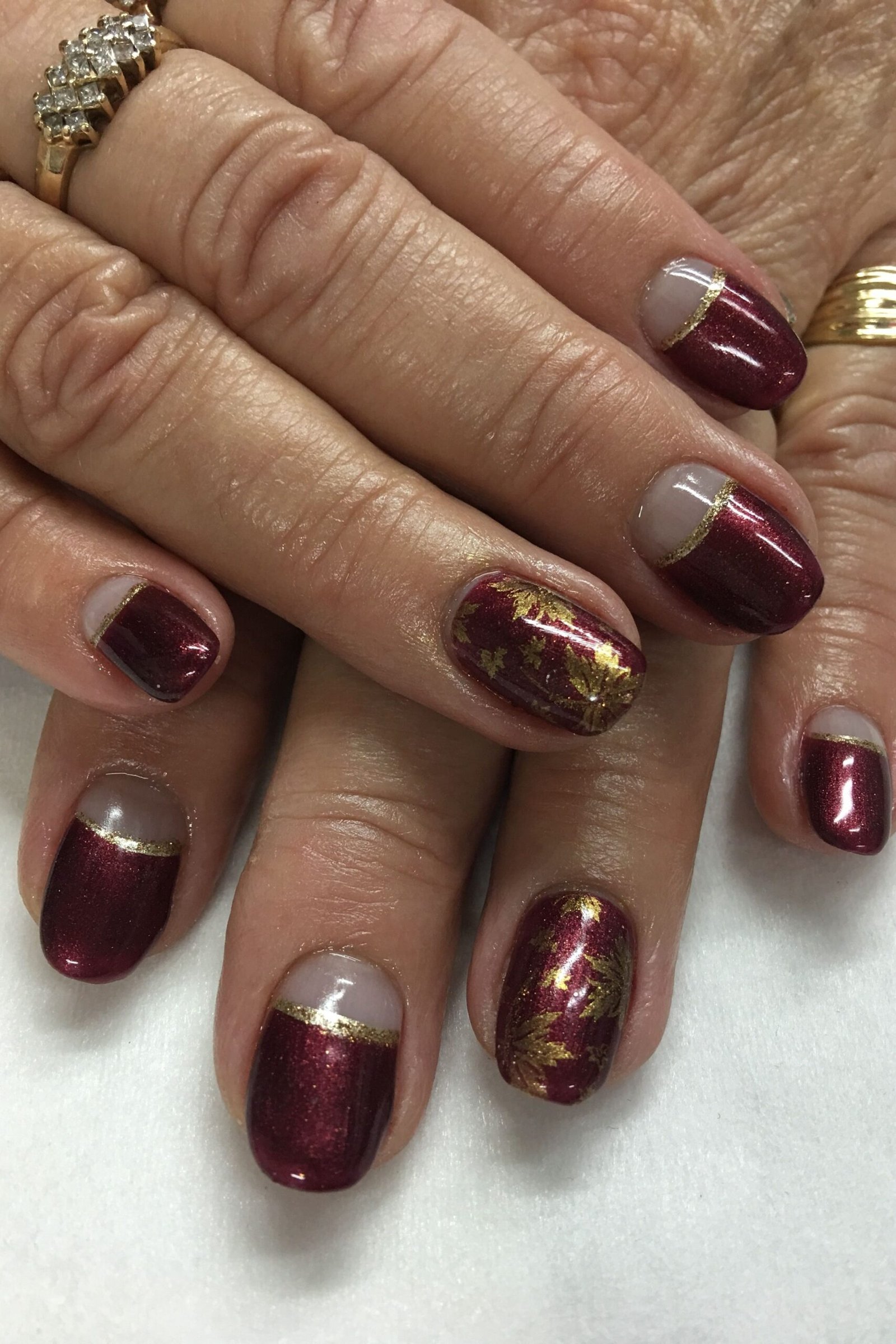 Burgundy Nails with Gold Foil French Lines for women over 50