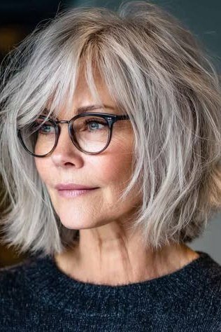Grey short shaggy bob with bangs and glasses for women over 60