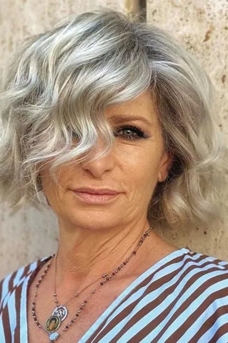 silver wavy bob with side swept fringe for women over 60