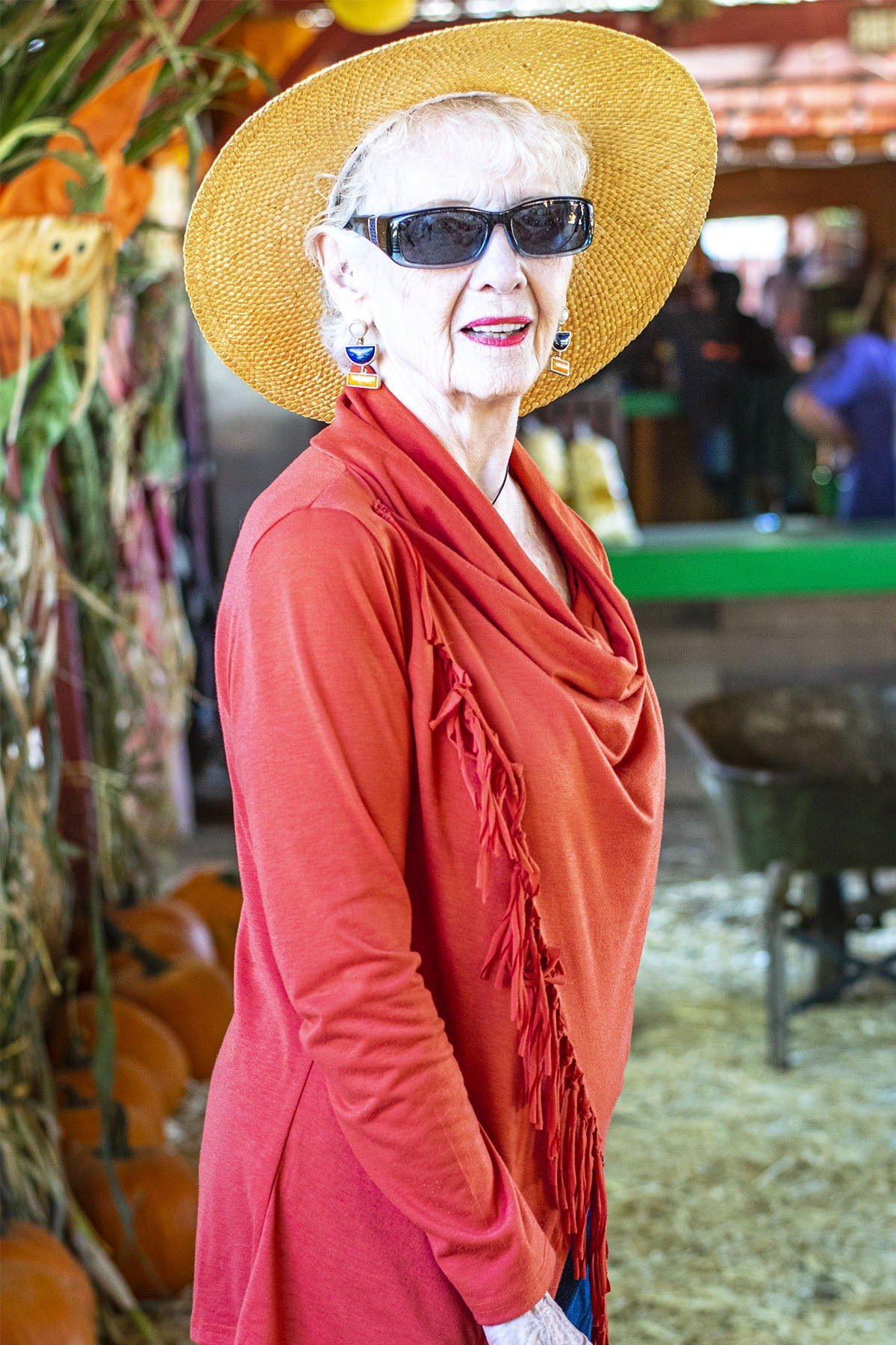 Thanksgiving outfit for women over 50: orange top with sun hat