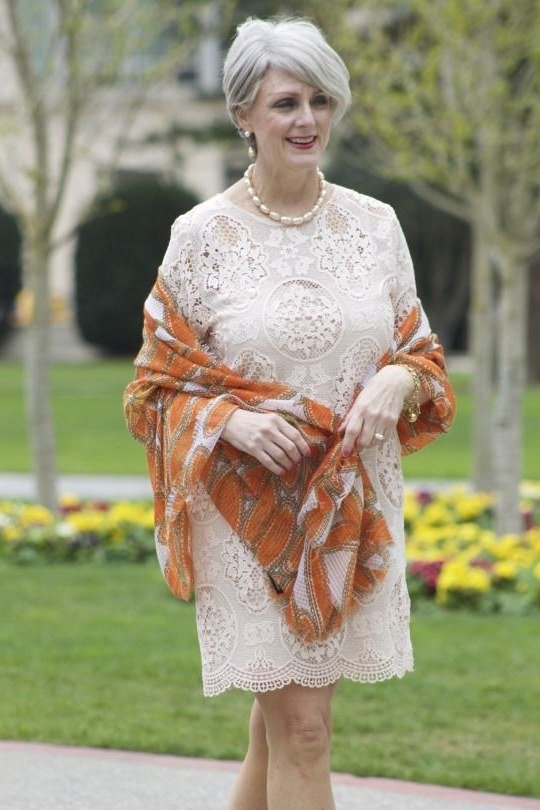 White lace dress with rust shawl