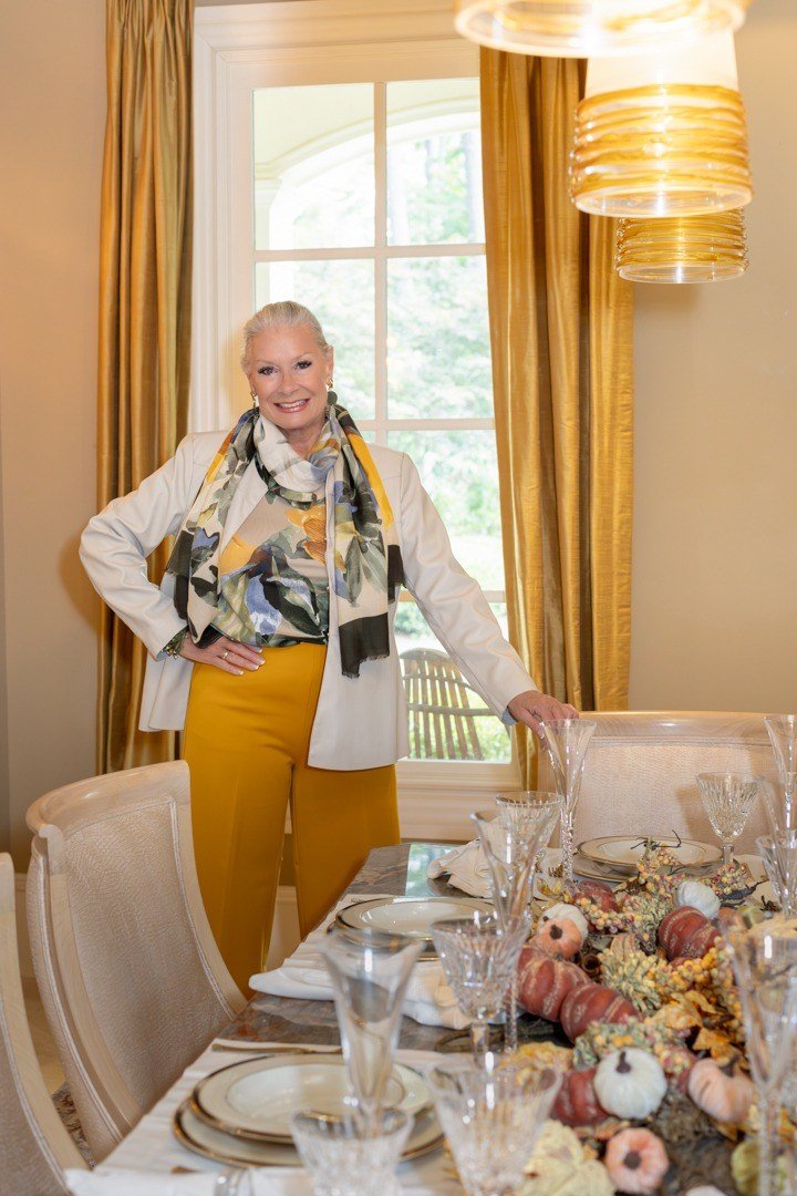 Thanksgiving outfit for women over 50: patterned jacket with mustard pants