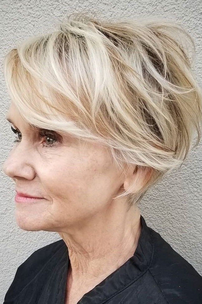 Side view of an older woman with a blonde textured bixie haircut.