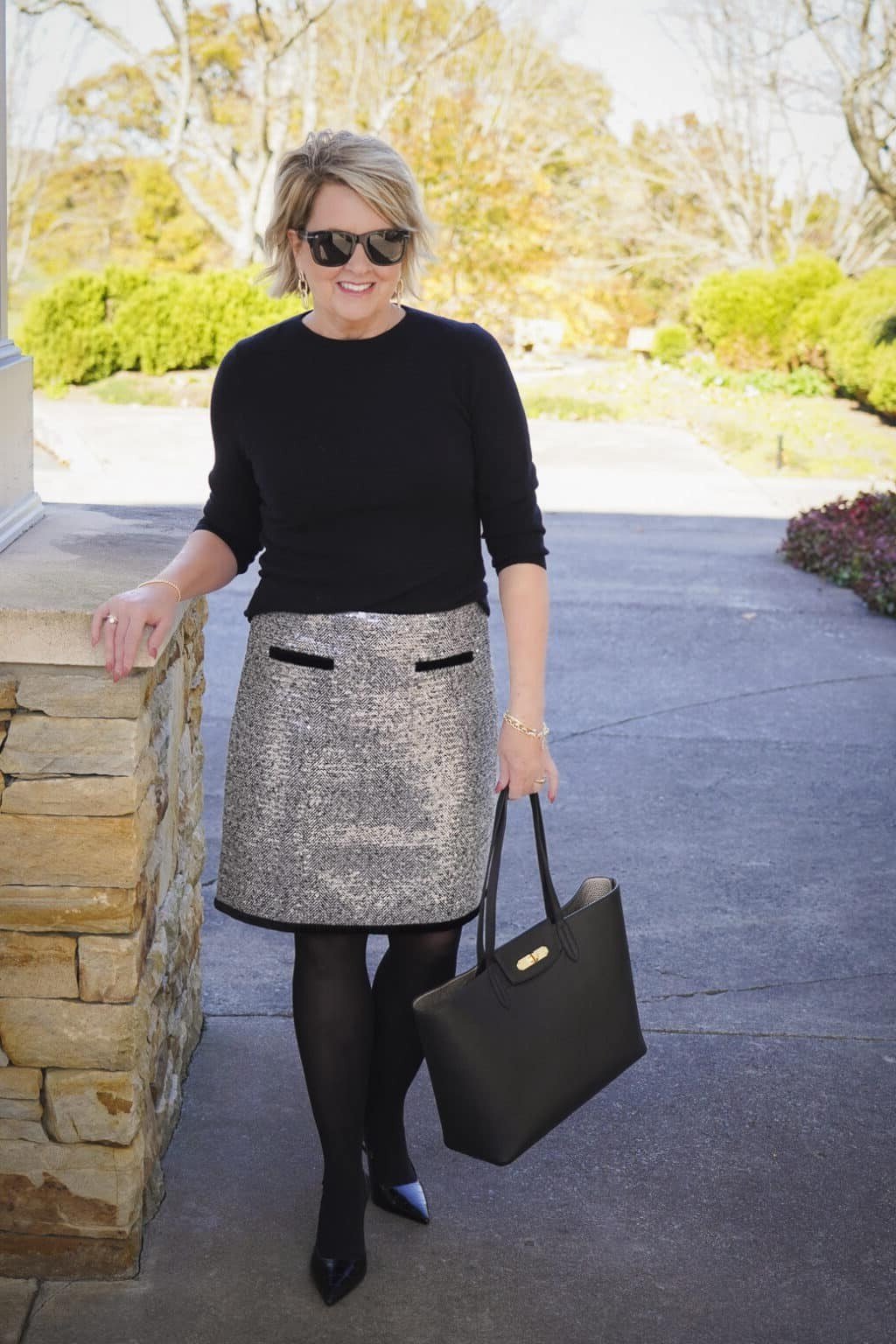 Thanksgiving outfit for women over 50: black sweater with metallic pencil skirt
