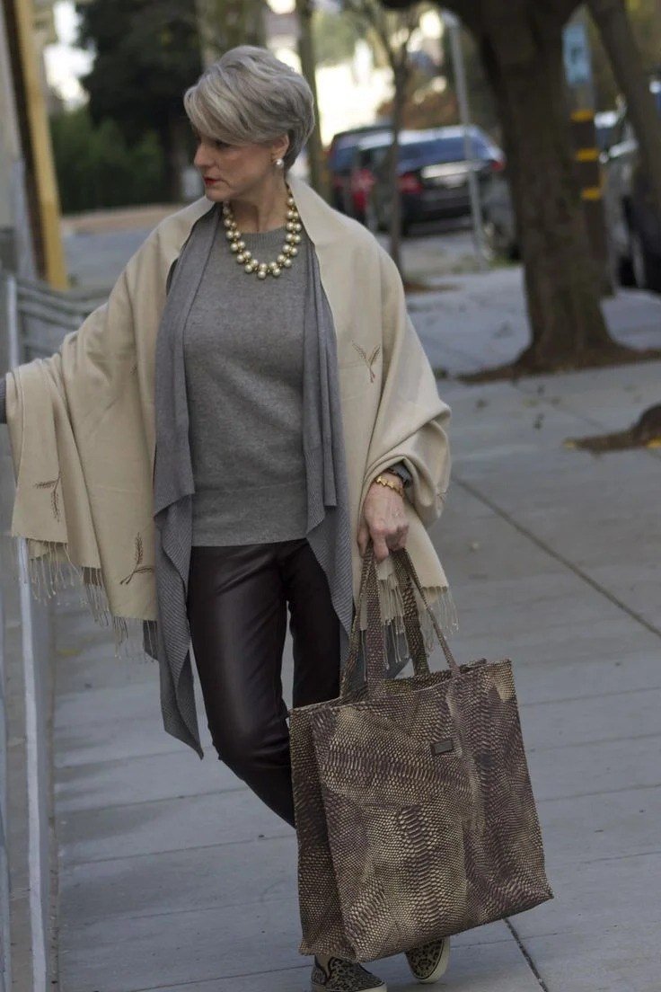 Thanksgiving outfit for women over 50: grey top with black leather pants