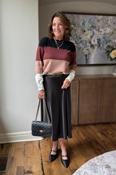 Thanksgiving outfit for women over 50: colorblock sweater with satin midi skirt
