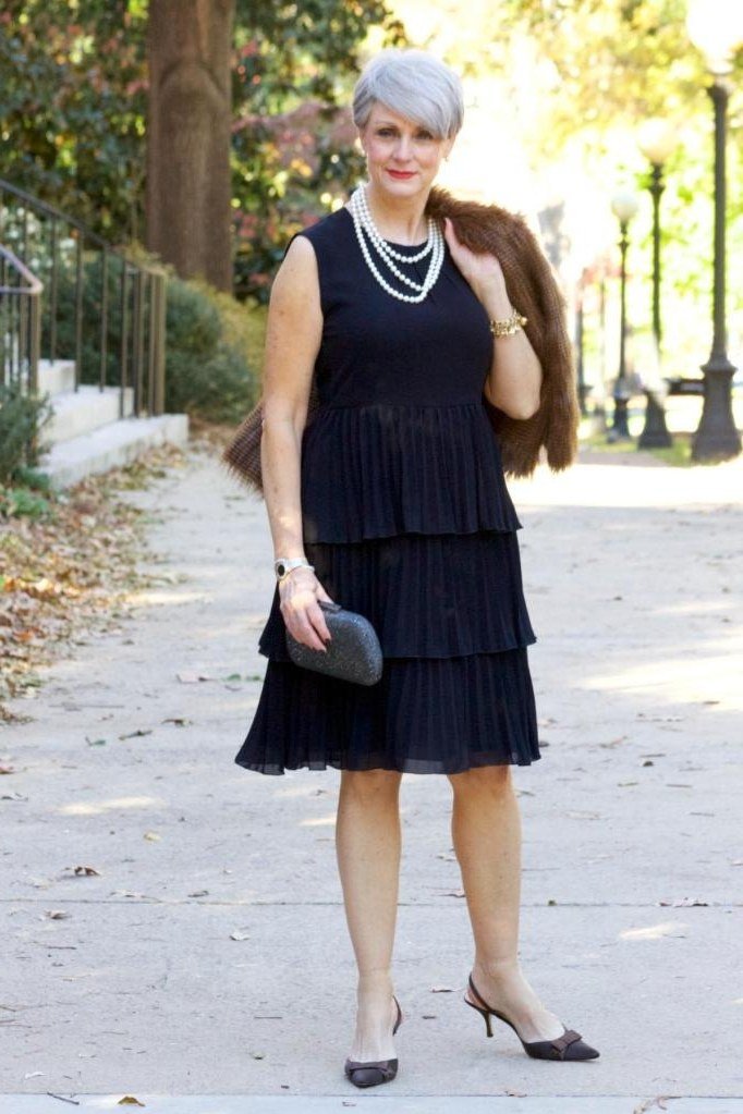 Thanksgiving outfit for women over 50: navy tiered dress with fur stole
