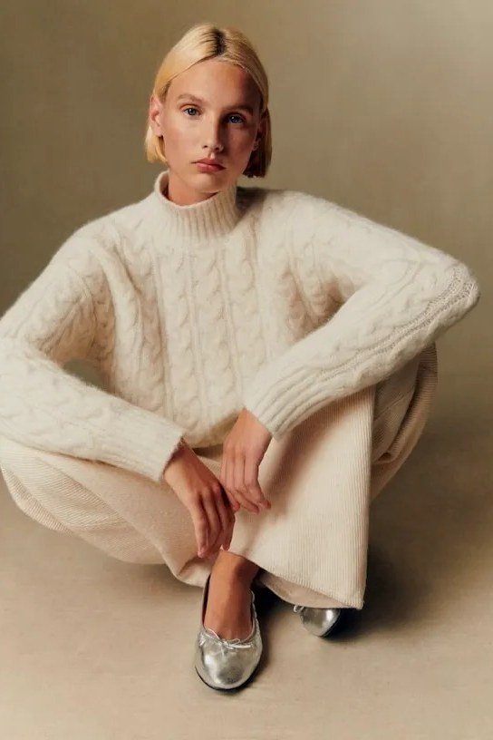 Thanksgiving outfit for women over 50: cream fisherman sweater with cream pants