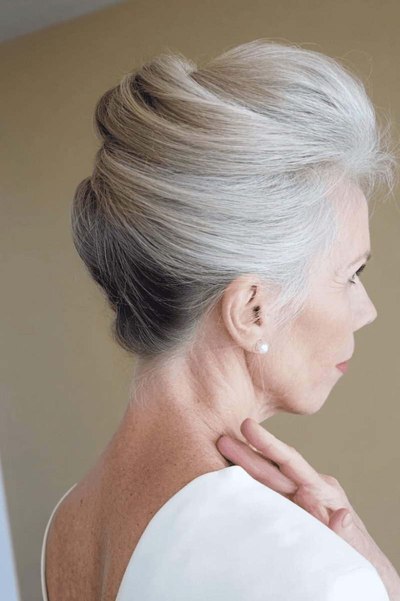 Silver high bun - hairstyle for women over 40