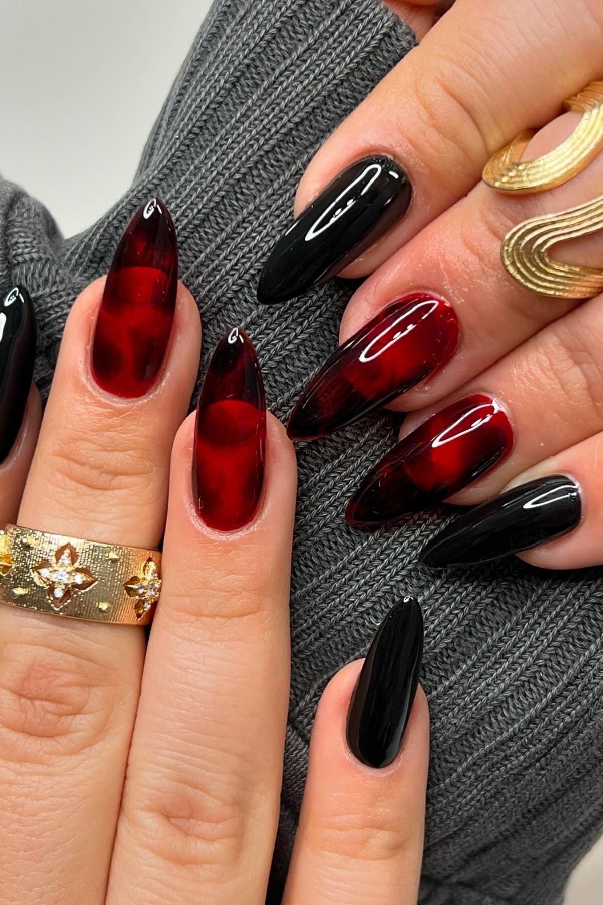 Black and translucent cherry red jelly stiletto nails with gold rings