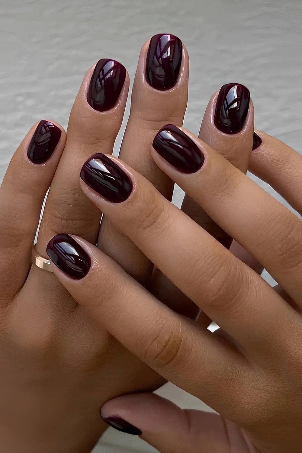 Cherry cola ombre almond nails with star nail art on mature hands