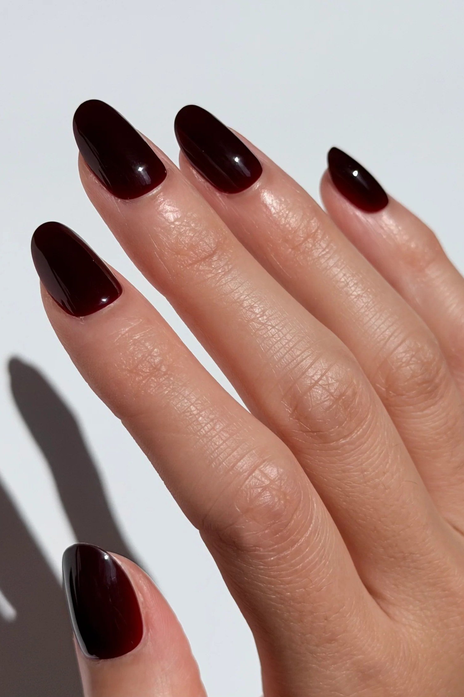 Glossy cherry cola almond nails