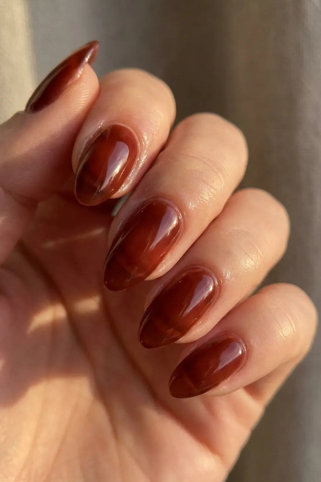 Glossy cherry cola oval nails