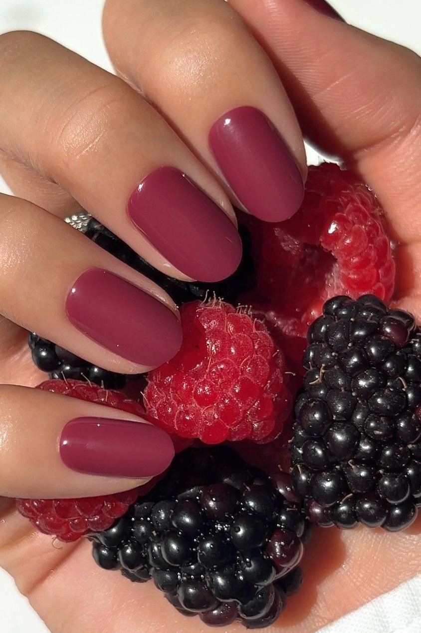 Berry squoval nails with hands holding fresh berries