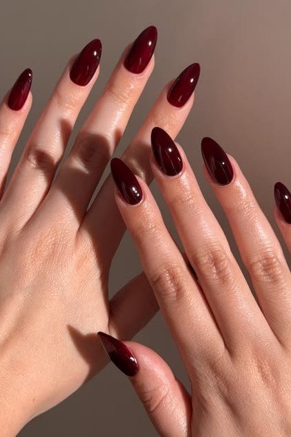 Cranberry almond nails with gold rings