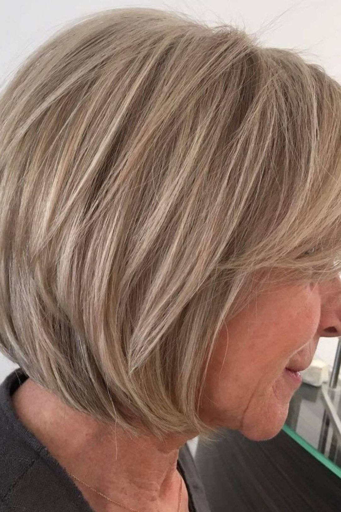 Rounded silver stacked bob in side/back three-quarter view