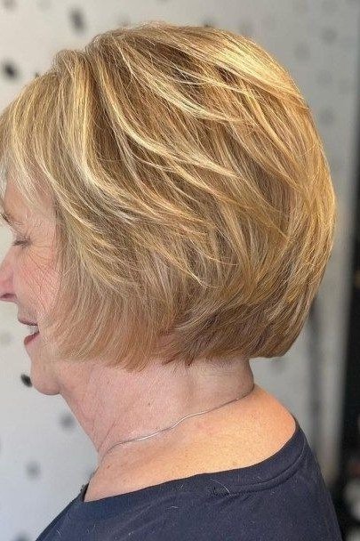 Sleek graduated blonde stacked layered bob in side view