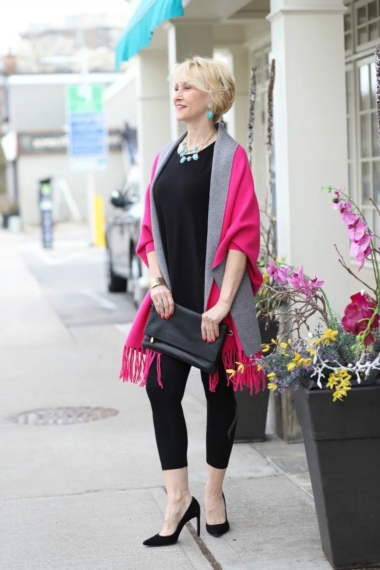 Magenta shawl over black top, black leggings, black heels, sidewalk, leggings outfit idea for women over 50