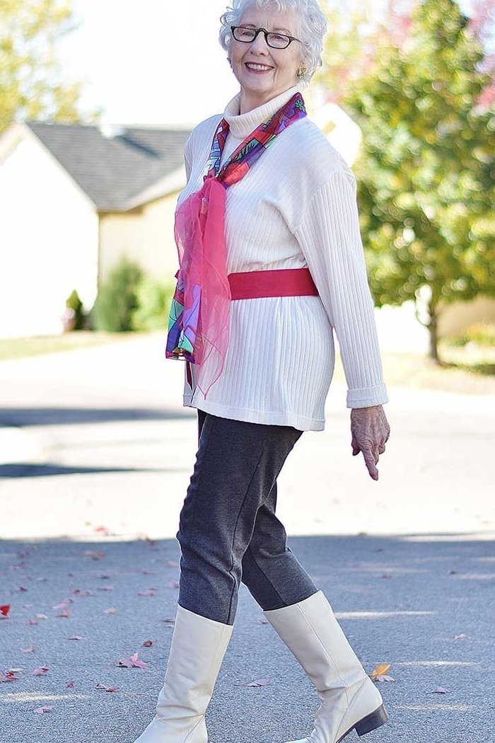 White tunic, black leggings, white knee boots, pink scarf, leggings outfit idea for women over 50