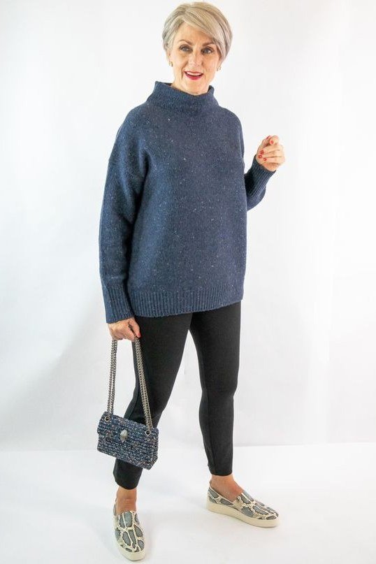 Navy mock-neck sweater, black leggings, snakeskin loafers, studio, leggings outfit idea for women over 50
