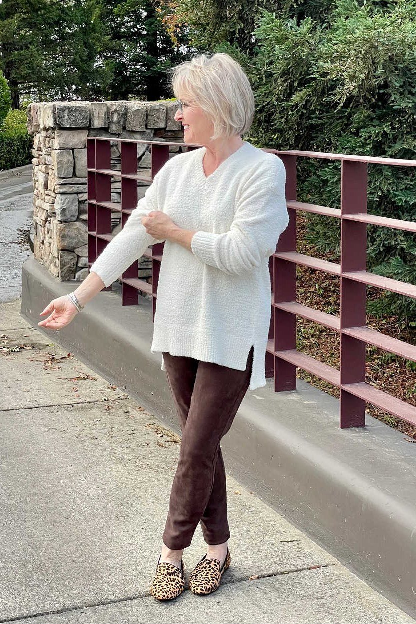 White tunic, brown leggings, leopard flats, bridge railing, leggings outfit idea for women over 50