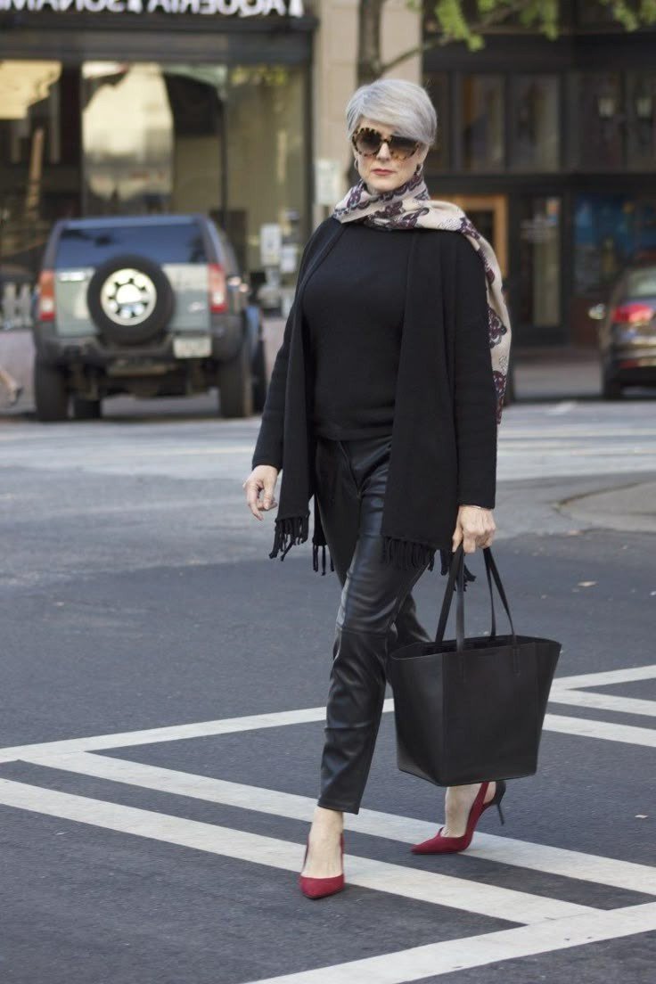 Black top, black faux-leather leggings, red heels, crosswalk street style, leggings outfit idea for women over 50