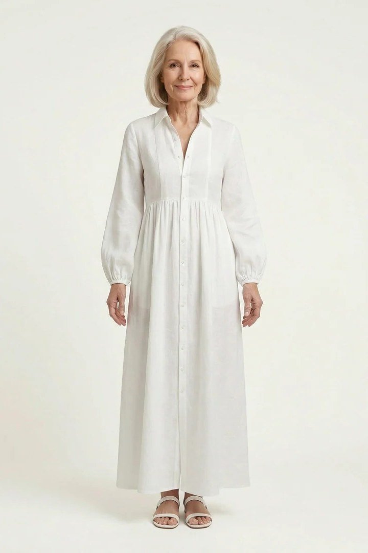 linen summer dresses for women over 60: older woman in white long-sleeve linen shirt dress maxi in studio