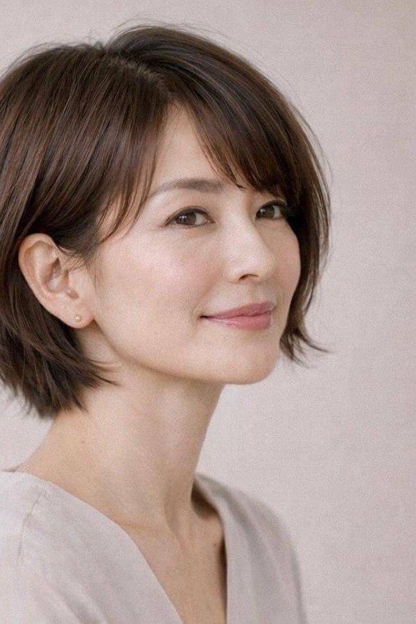 dark brown bob with curtain bangs, three-quarter view, low-maintenance hairstyle for women over 40