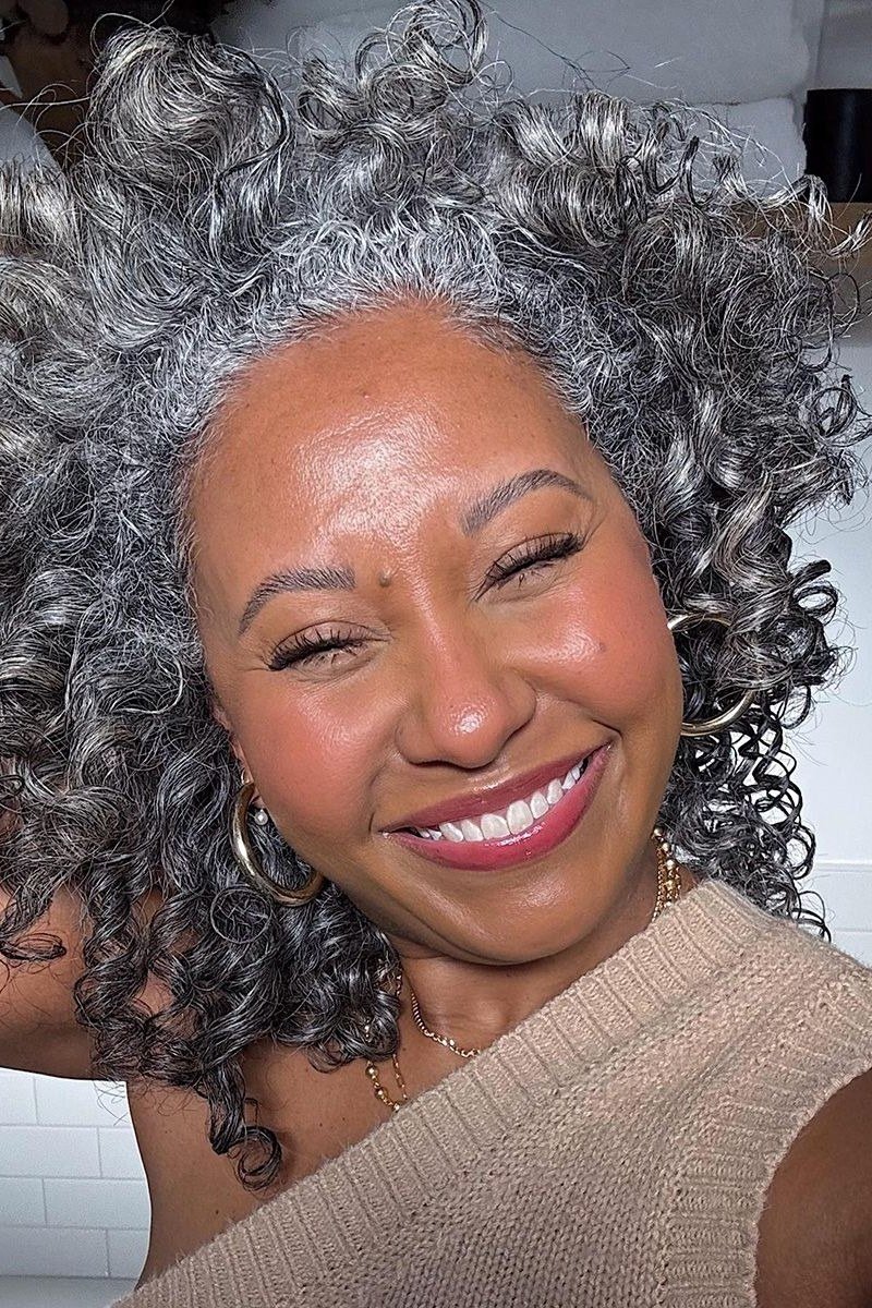 long silver curly hair with volume, front view, low-maintenance hairstyle for women over 40