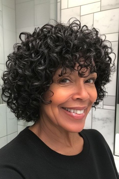 dark curly short bob with tight curls, front view, low-maintenance hairstyle for women over 40
