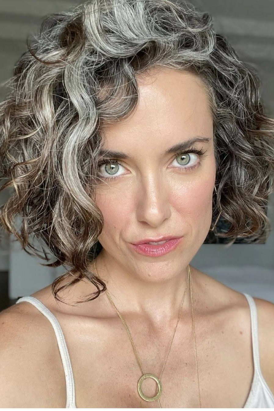 grey curly bob with full curls, front view, low-maintenance hairstyle for women over 40