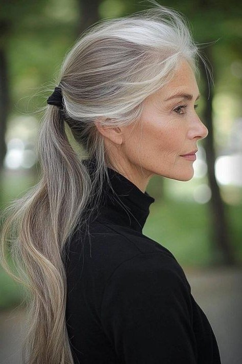 Grey Low Ponytail - long hairstyle for women over 60 with thin hair (grey low ponytail, side view, gathered pony)