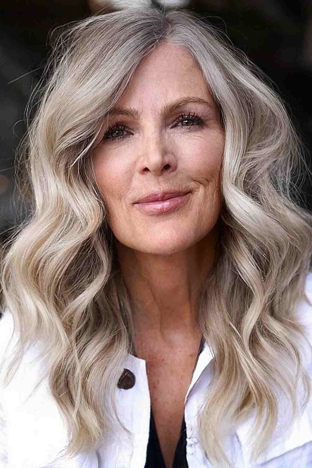 Soft Silver Wavy Length - long hairstyle for women over 60 with thin hair (silver wavy long hair, front view, soft glow)