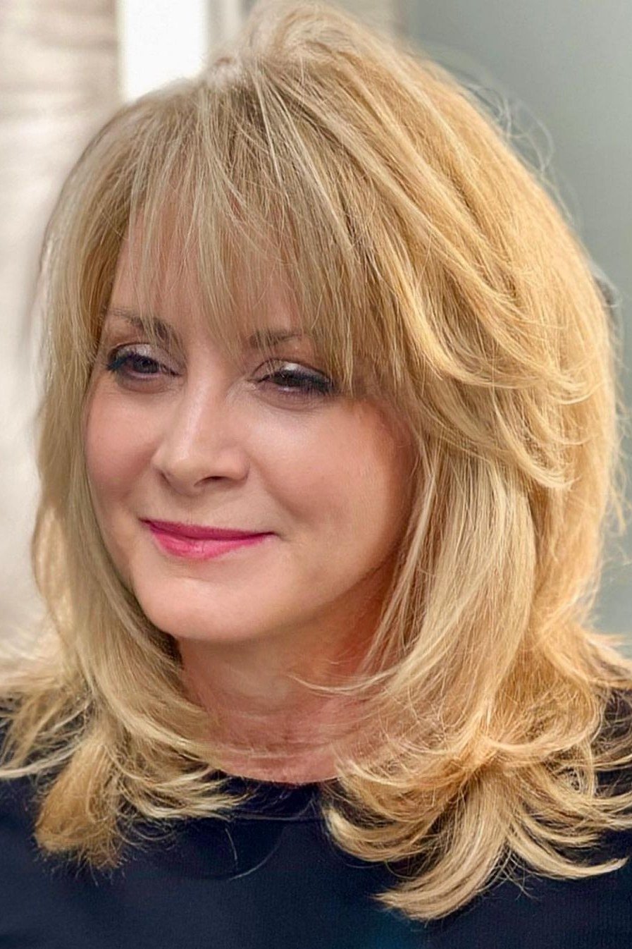 Blonde Wavy Cut with Bangs - medium-length haircut for women over 60 with fine hair