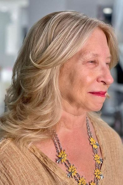Blonde Wavy Side Cut - medium-length haircut for women over 60 with fine hair