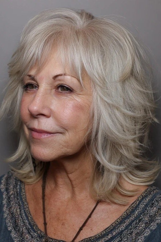 White flowing layered medium haircut for women over 60