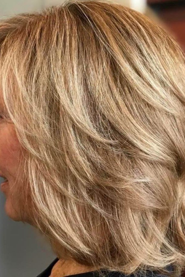 Blonde feathered medium layered haircut for women over 60